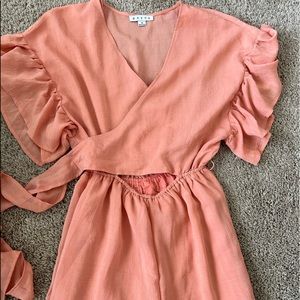 Light pink jumpsuit from Red Dress with open front and tie